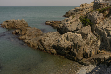 Rocky coastline landscape, natural daylight, peaceful sea view at Busan, South Korea, Haedong Yonggungsa Temple