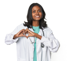Young Indian doctor with stethoscope smiling and showing a heart shape with hands.