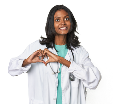 Young Indian doctor with stethoscope smiling and showing a heart shape with hands.