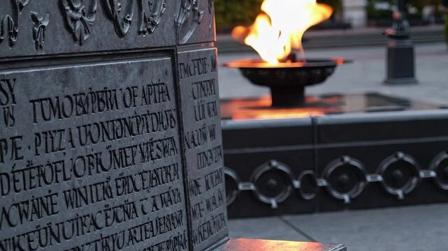Flame burning in a stone monument. Memorial stone with flames at the monument. A solemn reflection of history and remembrance outdoors. A fire flickering within a stone structure lifestyle.