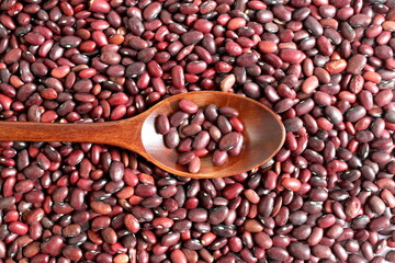 There is a wooden spoon on the red bean texture.