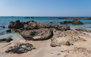 single stones on the sandy coast of the Mediterranean Sea on the island of Crete