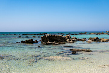 single stones on the sandy coast of the Mediterranean Sea on the island of Crete