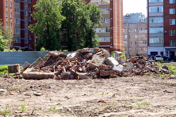 A pile of construction waste lies around in the summer.	