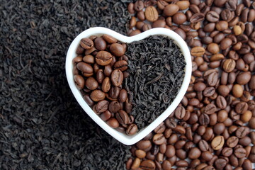 There is tea and coffee in a white heart-shaped cup.