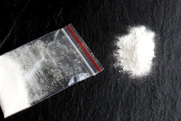 There is a bag of drugs on a black background.	