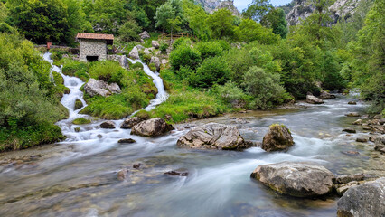 Water mill and Cares river at Cain de Valdeon, Ruta del Cares route, Picos de Europa National Park, Valdeon council, Leon province, Spain