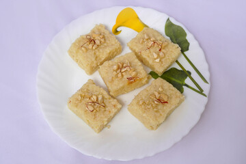 Indian Diwali sweet food Kalakand also know as halwa or mawa kalakand, garnished with cashew nut and saffron Isolated on white background.