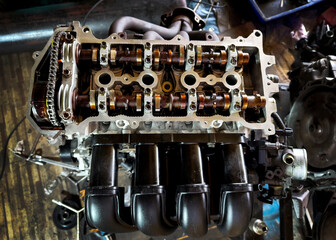 A car engine is being worked on inside a garage workshop