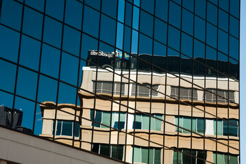 Abstract glass skyscraper reflections showing a distorted adjacent building in the reflecting window grid_20101017_03978.