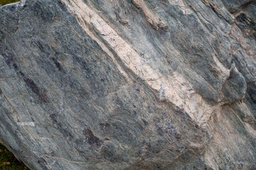 Stone Background. Textured metamorphic rock surface with visible striations. Geological and natural texture references.