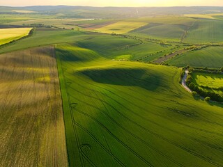 Beautiful spring landscape with field, hills and sunset. Czech Republic - South Moravia (Moravian Tuscany.) Concept for agriculture, travel, environment and nature.