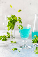 Colorful refreshing summer drink with basil seeds on light background.