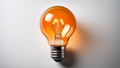 orange light bulb glowing brightly against a white background symbolizing creativity and innovation