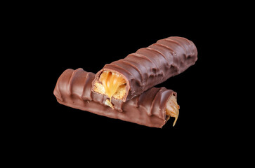 Sweet chocolate candy bar on black background, close-up