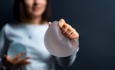 Lady showing flexible silicone. A woman squeezes a soft silicone object, showing its flexibility...