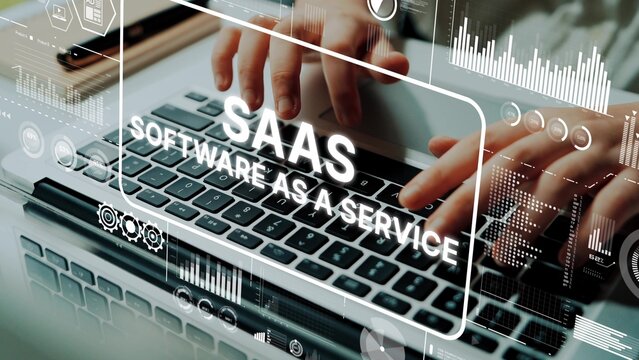Hands Typing on Keyboard with Graphic Overlay Representing SaaS Software as a Service Concept in Modern Workspace. Asymptotic smart data analytic.