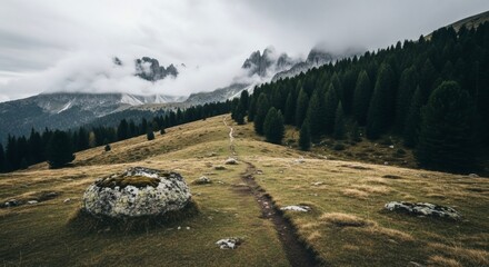 Hiking trail through the dolomites italy mountains with clouds and forest scenic landscape photography