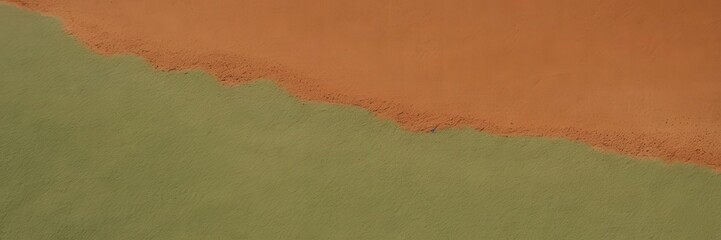 Abstract close-up of textured orange and green materials blending at the edge, creating a striking contrast and dynamic interplay between color, form, and surface detail. 
