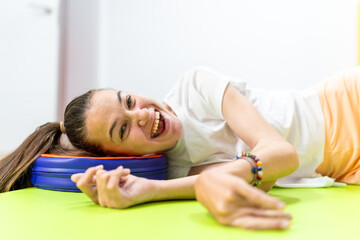 Young Woman with Cerebral Palsy Relaxing on the Floor Mat with a Smile - She enjoys a peaceful...