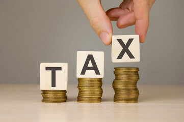 word tax and stacks of coins