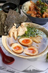 Authentic Japanese Ramen Bowl with Marinated Eggs and Grilled Chicken in Cozy Ramen Bar