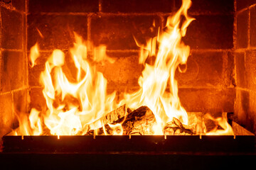Closeup fire inside traditional fireplace, orange flames dancing, rustic home setting, cozy winter scene, warm lighting effect, evening cabin comfort