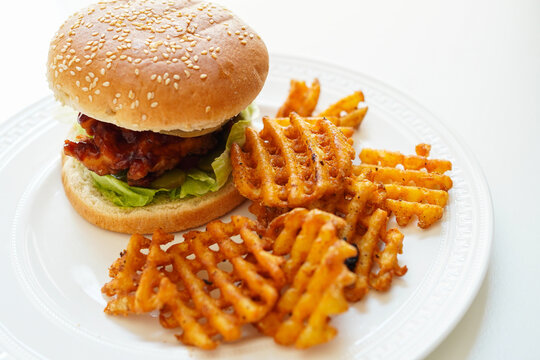 Delicious fried chicken burger and fried waffle potato on white background - Powered by Adobe