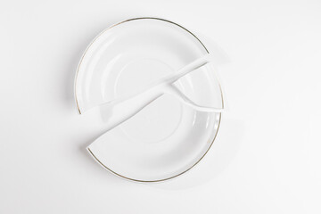 Shattered Ceramic Plate Isolated on White – Fragility and Imperfection Theme