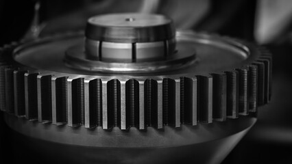 A close up of a gear with a black and white filter. Concept of precision and complexity, as gears...
