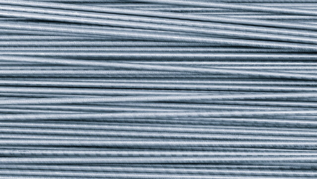 Row metal rods are shown in blue as texture background rods are arranged in way that they are touching each other. image has sense of order and structure, with rods forming neat line.