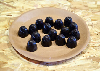Chocolates lie on a cardboard plate