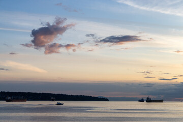Scenic Sunset View Near Stanley Park in Vancouver, BC Featuring Boats and Distant Horizon