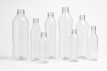 Collection of clear plastic bottles in different shapes and sizes. Ideal for illustrating packaging, recycling, plastic waste, or product mockups.

