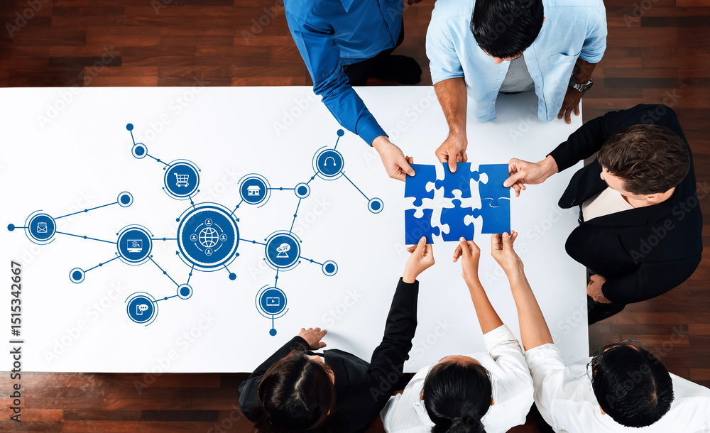 Fototapete A diverse team collaborates around a table, connecting puzzle pieces and exploring digital networks to develop innovative business strategies and solutions. Amity