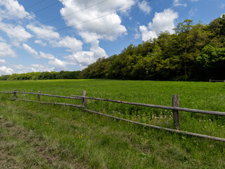 A field with a wooden fence in the middle of it