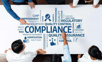 A diverse group of professionals collaborates in a compliance workshop, analyzing essential quality...