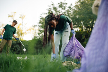 Volunteers picking up trash in a public park