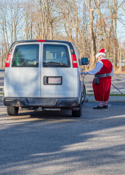 man dressed as santa entering white van with cane