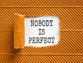 Nobody is perfect symbol. Concept words Nobody is perfect on beautiful white paper. Beautiful brown...