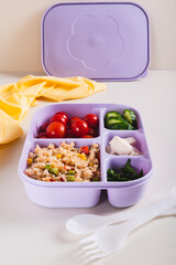 Homemade lunchbox with meat, vegetables and cereals for lunch at work on the table vertical view