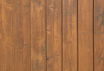 Fototapeta premium Close-up full-frame vertical wooden planks, rich brown finish and visible natural wood grain. Rustic texture and organic pattern, wallpaper background. Carpentry, architecture countryside visuals. 