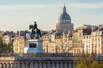Statue of Henry IV on Cite island and Pantheon dome in Paris, France