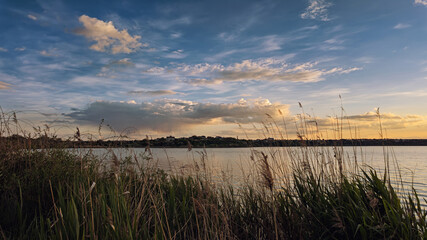 Peaceful sunset over a lake shoreline