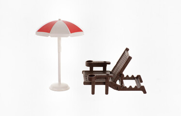 toy beach umbrella and toy hammock isolated on white background