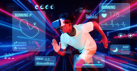 Healthy man making running posture while looking at hologram. Attractive male model playing fitness...