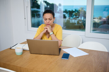 Focused Female Professional Working Remotely from Home Office by the Beach