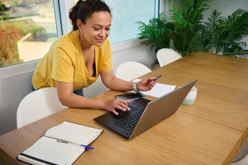 Confident Female Entrepreneur Working from Home on Business Plans