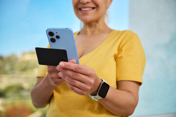 Woman Using Smartphone for Online Transaction Outdoors in Daylight