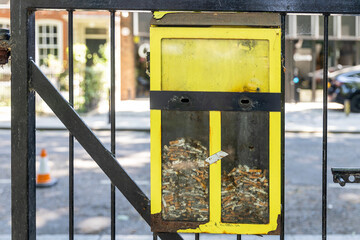 Yellow Ballot Bin full of cigarette butts.